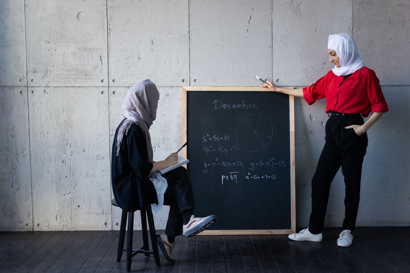 A qualified female tutor going over a lesson one-on-one with her student